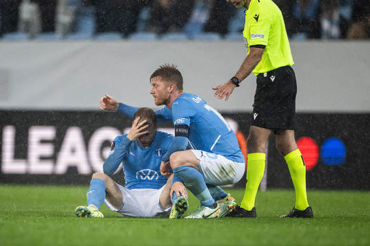 Oscar Lewicki of Malmö in pain, gets assistance by Anders