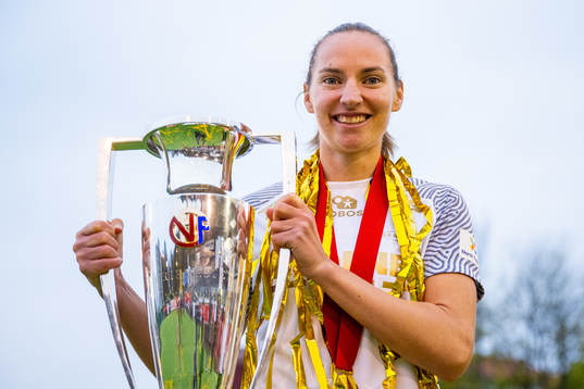 Marit Bratberg Lund of Brann celebrates with the trophy