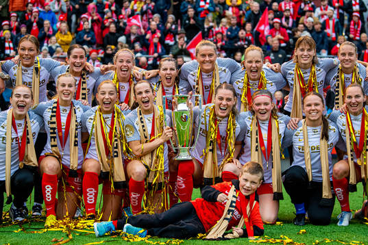 Players of Brann celebrate with the trophy