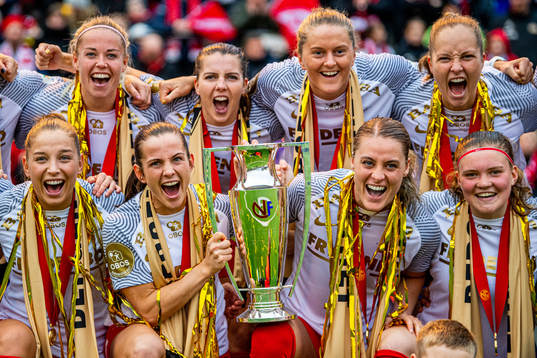 Players of Brann celebrate with the trophy