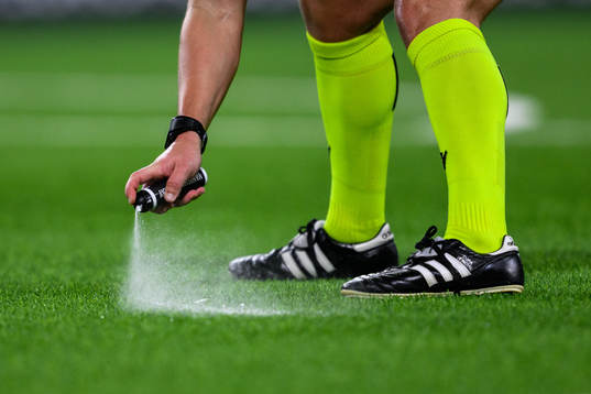 A referee using a vanishable spray