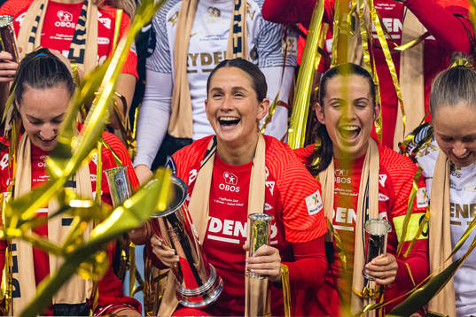Ingrid Ryland of Brann celebrates with the trophy