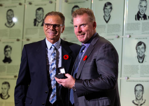 Daniel Alfredsson is presented with his ring by Mike Gartner