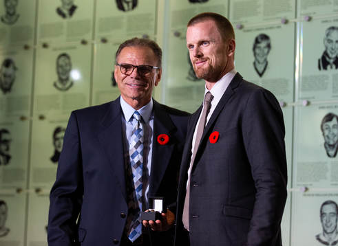Daniel Sedin is presented with his ring by Mike Gartner