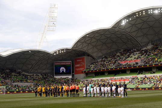 Both teams line up for the national anthems