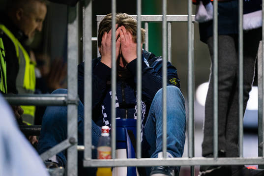 Spectators in the stands looks dejected