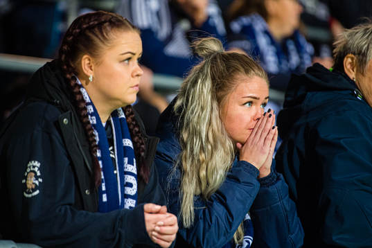 Spectators in the stands looks dejected
