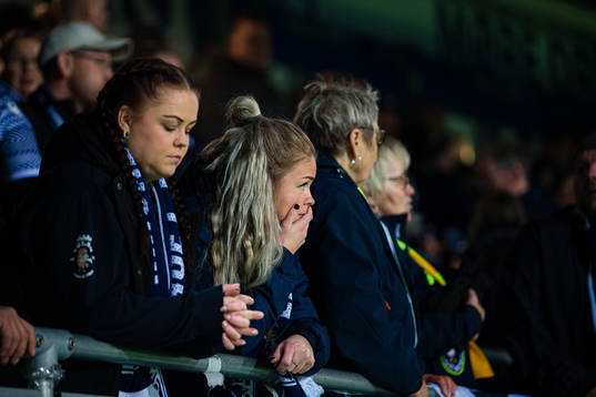 Spectators in the stands looks dejected