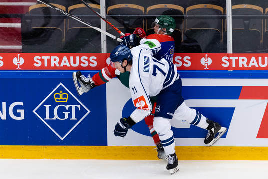 Trenton Bourque of Straubing Tigers hits Ryan Lasch of
