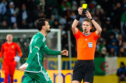 Ramy Bensebaini of Algeria receives a second yellow card