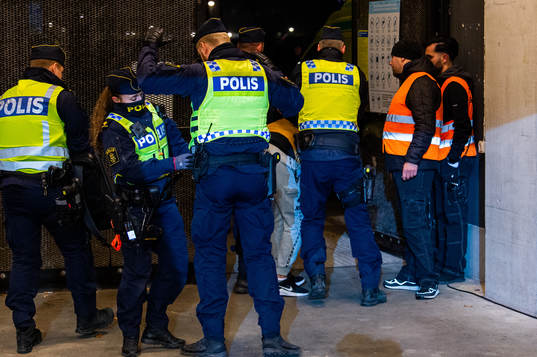 Police detain a pitch invader