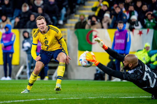 Viktor Claesson of Sweden and goalkeeper Rais Mbolhi of