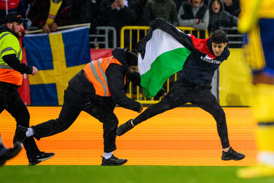 Security personal chases a pitch invader