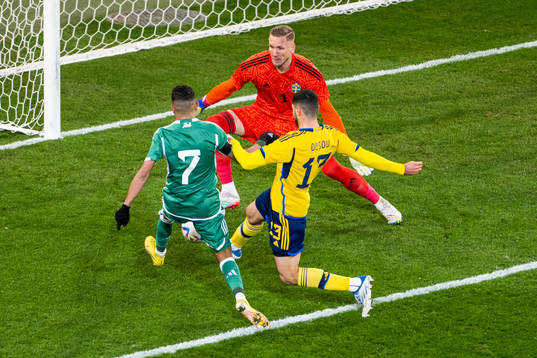 Riyad Mahrez of Algeria attacks against goalkeeper Robin