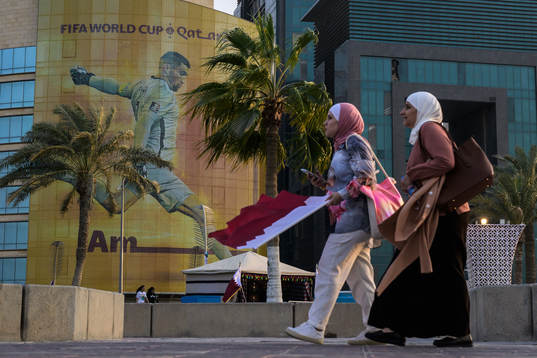 Women walk past advertising