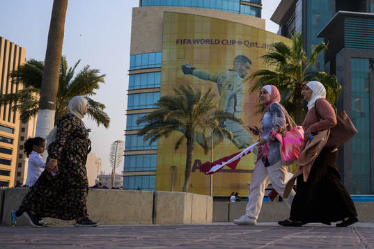 Women walk past advertising