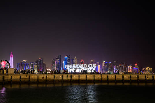 The city skyline seen behind a World Cup logo at Corniche