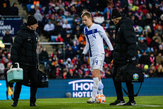Robert Ivanov of Finland leaves the pitch with an injury