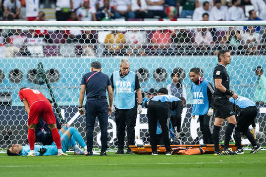 Goalkeeper Alireza Beiranvand of Iran receives medical