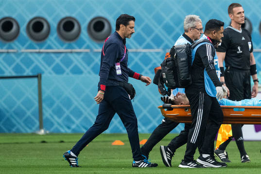 Goalkeeper Alireza Beiranvand of Iran is carried away in a