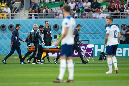 Goalkeeper Alireza Beiranvand of Iran is carried away in a