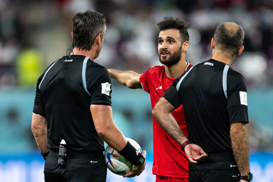 Ahmad Noorollahi of Iran and referee Raphael Claus