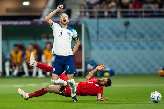 Harry Kane of England and Morteza Pouraliganji of Iran