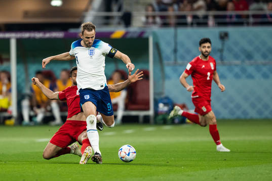 Harry Kane of England and Morteza Pouraliganji of Iran