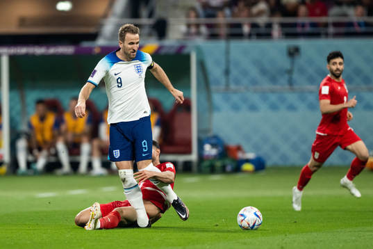 Harry Kane of England and Morteza Pouraliganji of Iran