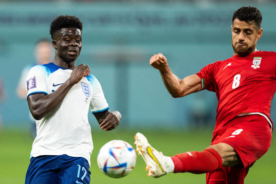 Bukayo Saka of England and Morteza Pouraliganji of Iran