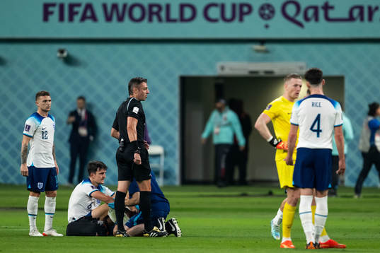 Harry Maguire of England receives medical attention