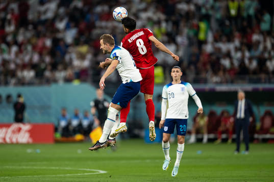 Harry Kane of England and Morteza Pouraliganji of Iran