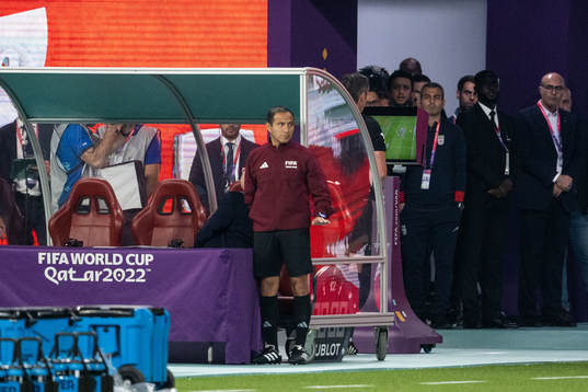 Referee Raphael Claus with a VAR review