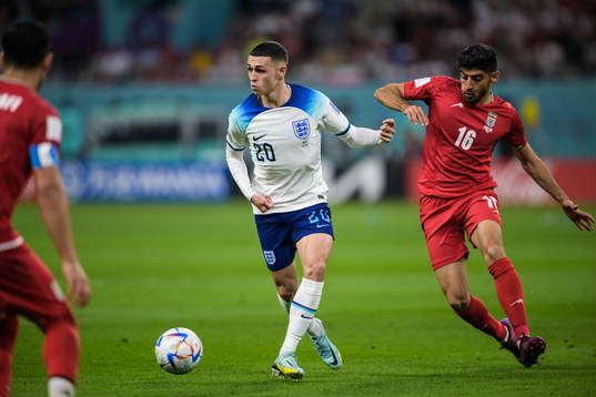 Phil Foden of England and Mehdi Torabi of Iran