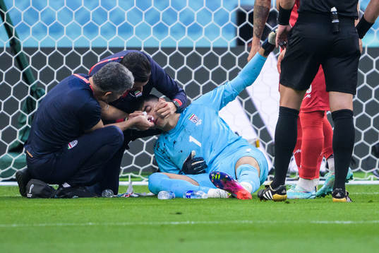 Goalkeeper Alireza Beiranvand of Iran receives medical