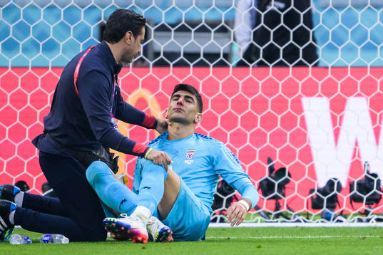 Goalkeeper Alireza Beiranvand of Iran receives medical