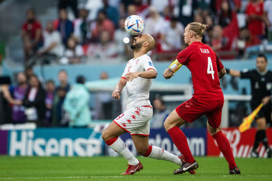 Issam Jebali of Tunisia and Simon Kjær of Denmark