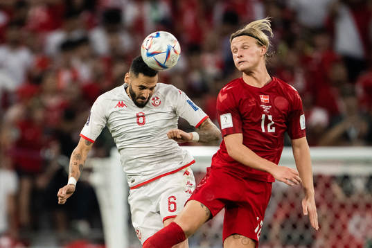 Dylan Bronn of Tunisia and Kasper Dolberg of Denmark