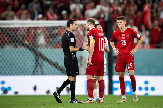 referee Cesar Ramos and Christian Eriksen of Denmark