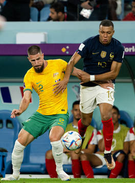 Milos Degenek of Australia and Kylian Mbappe of France