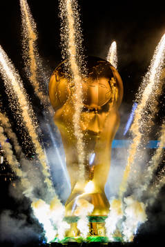 Fireworks around a large inflatable World Cup trophy