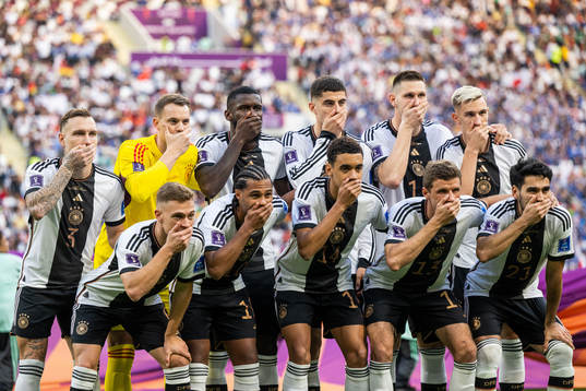 The starting eleven of Germany hold their hands over their