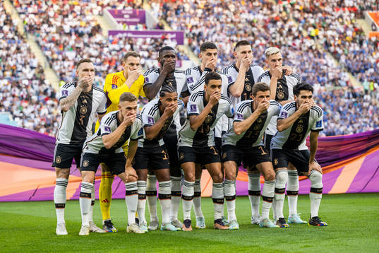 The starting eleven of Germany hold their hands over their