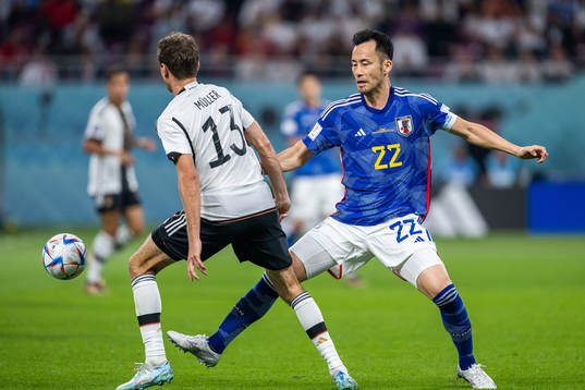 Thomas Müller of Germany and Maya Yoshida of Japan