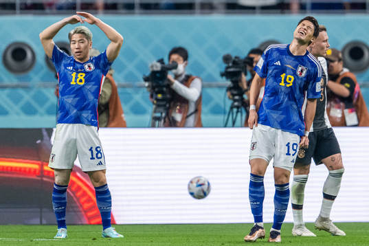 Takuma Asano and Hiroki Sakai of Japan look dejected
