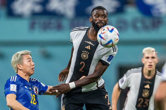 Takuma Asano of Japan and Antonio Rüdiger of Germany