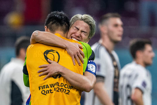 Takuma Asano of Japan celebrates with a team mate