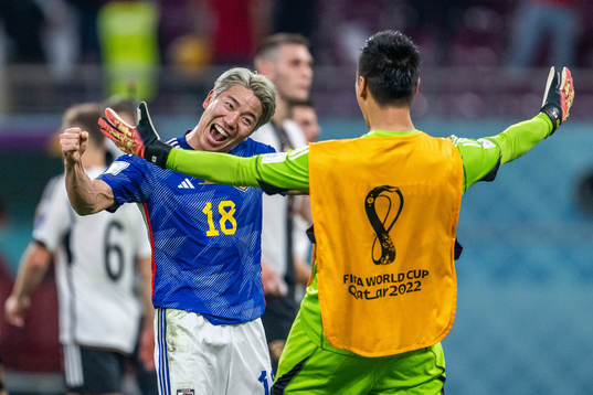 Takuma Asano of Japan celebrates with a team mate