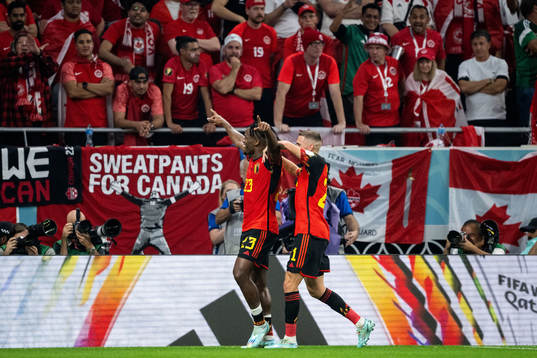 Michy Batshuayi of Belgium celebrates with Timothy Castagne