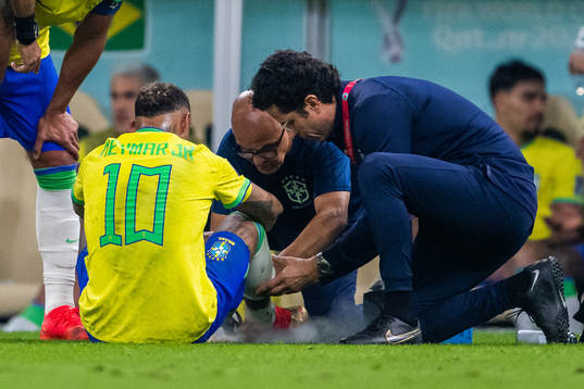 Neymar of Brazil receives medical attention